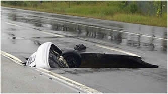 Collapsed steel sewer causes sinkhole in Canadian highway.  Concrete pipe provides fix.